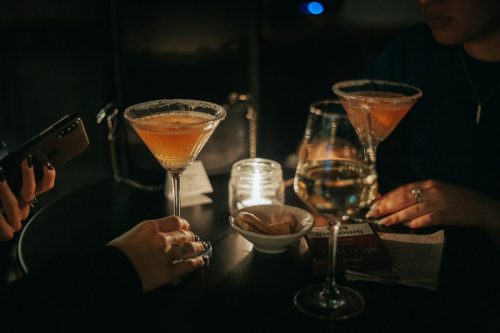 a group of people sitting at a table with drinks